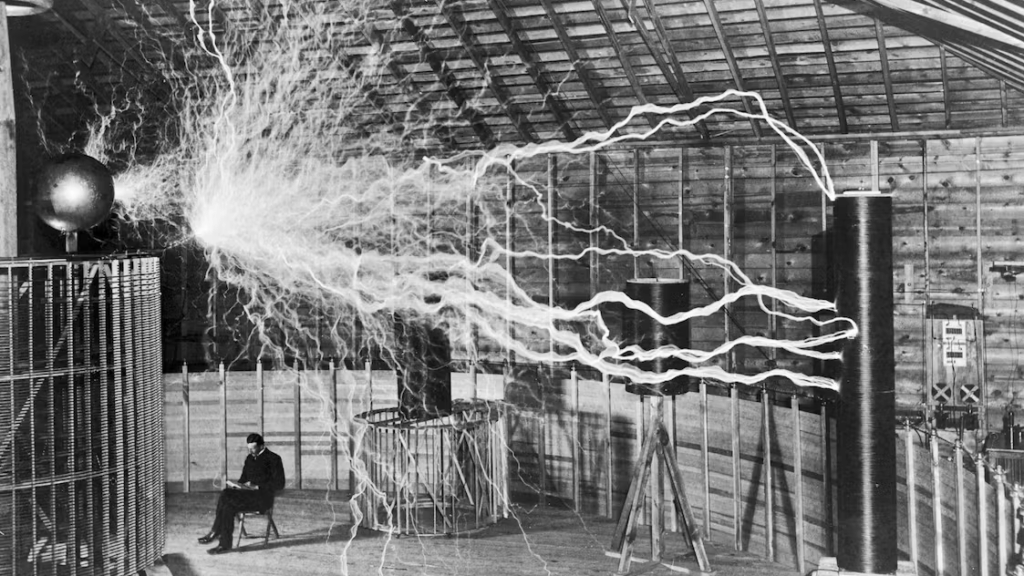 An 1899 photo of Tesla working in his laboratory, complete with lots of lightning bolts.